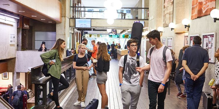 People walking and chatting in Guildhall Silk Street foyer