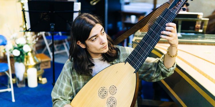 Guildhall theorbo player rehearsing in a church